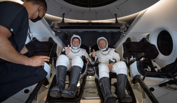 NASA astronauts Robert Behnken, left, and Douglas Hurley are seen inside the SpaceX Crew Dragon Endeavour spacecraft